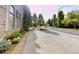 View of driveway leading to a luxury estate with mature landscaping and a gated entrance at 106 S University Blvd # 5, Denver, CO 80209