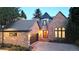 Exterior elevation of a brick home featuring a turret, front-entry garage, and professional landscaping at 106 S University Blvd # 5, Denver, CO 80209