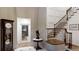 Foyer showcasing curved staircase, a grandfather clock and views into an adjacent wine cellar at 106 S University Blvd # 5, Denver, CO 80209