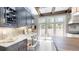 Kitchen featuring gray cabinets, quartz countertops, a view to an outdoor space and stainless steel appliances at 106 S University Blvd # 5, Denver, CO 80209