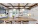 Bright kitchen featuring wood beams, a large center island, and modern light fixtures at 106 S University Blvd # 5, Denver, CO 80209