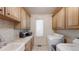 Functional laundry room with ample cabinetry, a sink, tile floors and plenty of counter space at 106 S University Blvd # 5, Denver, CO 80209