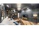 Cozy living room with custom bookshelves, dark paneled walls, chandelier lighting, and comfortable seating at 106 S University Blvd # 5, Denver, CO 80209