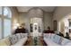 Living room featuring an arched doorway, hardwood floors, and white couches at 106 S University Blvd # 5, Denver, CO 80209