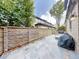 Spacious back patio featuring a stone privacy wall and outdoor seating area at 106 S University Blvd # 5, Denver, CO 80209