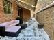 Covered patio with seating area and brick wall at 106 S University Blvd # 5, Denver, CO 80209