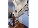 Grand staircase with wrought iron railing and wood flooring at 106 S University Blvd # 5, Denver, CO 80209