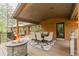Back deck features outdoor seating, a fireplace, grill, and dining, all ideal for entertaining at 7597 Molas Ct, Larkspur, CO 80118