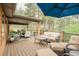 Relax on this spacious back deck, which features outdoor furniture, seating, and lovely wooded views at 7597 Molas Ct, Larkspur, CO 80118