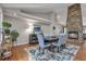 Dining room featuring hardwood floors and views of a stone fireplace at 7597 Molas Ct, Larkspur, CO 80118