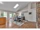 Bright dining room features hardwood floors, skylight, and stylish rug under the wood dining table at 7597 Molas Ct, Larkspur, CO 80118