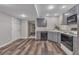 Kitchen features stainless steel appliances, grey cabinets, and durable wood-look flooring at 7597 Molas Ct, Larkspur, CO 80118