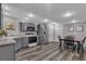 Updated kitchen features modern appliances, grey cabinetry, and a cozy dining area at 7597 Molas Ct, Larkspur, CO 80118