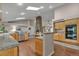 Open kitchen showcases granite counters, wood cabinets, skylights, fireplace, and stainless steel appliances at 7597 Molas Ct, Larkspur, CO 80118