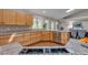 Open kitchen with granite counters, natural wood cabinets, hardwood floors, and stainless appliances at 7597 Molas Ct, Larkspur, CO 80118