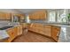 Bright kitchen featuring granite counters, stainless appliances, hardwood floors, and natural wood cabinets at 7597 Molas Ct, Larkspur, CO 80118