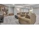 Cozy living room with stone fireplace, plush carpet, and comfortable seating arrangement at 7597 Molas Ct, Larkspur, CO 80118