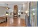 Spacious living room with a soaring stone fireplace and an open layout to the dining room at 7597 Molas Ct, Larkspur, CO 80118