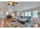 Bright living room with large sectional, vaulted ceilings, hardwood floors, and large windows with a view at 7597 Molas Ct, Larkspur, CO 80118