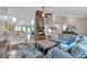 Open concept living room featuring a stone fireplace, hardwood floors, and a comfortable sectional at 7597 Molas Ct, Larkspur, CO 80118