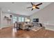 Bright living room with vaulted ceilings, hardwood floors, a large window, and an ceiling fan at 7597 Molas Ct, Larkspur, CO 80118