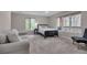Bright main bedroom with a wooded view, a sitting area and neutral decor at 7597 Molas Ct, Larkspur, CO 80118