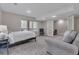 Bright main bedroom with a wooded view, a sitting area and neutral decor at 7597 Molas Ct, Larkspur, CO 80118