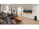 Finished basement with sectional sofa, large screen TV, and game area at 2975 Thunder Lake Cir, Lafayette, CO 80026
