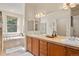 Bathroom with double vanity, soaking tub, and walk-in shower at 2975 Thunder Lake Cir, Lafayette, CO 80026