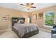 Bedroom with ceiling fan, large window, and built-in storage at 2975 Thunder Lake Cir, Lafayette, CO 80026