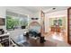 Home office with built-in shelving, large window, and view to dining room at 2975 Thunder Lake Cir, Lafayette, CO 80026