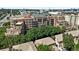 Stunning aerial view of a brick condominium with lush greenery in a vibrant cityscape at 2400 E Cherry Creek South Dr # 307, Denver, CO 80209