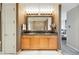 Bathroom featuring a double sink vanity with granite countertops and a large mirror with custom lighting at 2400 E Cherry Creek South Dr # 307, Denver, CO 80209