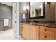 Bathroom with marble countertops, wood cabinets, and tile flooring at 2400 E Cherry Creek South Dr # 307, Denver, CO 80209