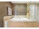 Bathroom with a soaking tub, glass-enclosed shower, and mosaic accent wall at 2400 E Cherry Creek South Dr # 307, Denver, CO 80209