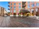 Inviting entrance to a brick condominium with a covered entryway and beautifully landscaped grounds at 2400 E Cherry Creek South Dr # 307, Denver, CO 80209