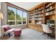 Bright home office with large windows, built-in bookshelves, and a comfortable seating area at 2400 E Cherry Creek South Dr # 307, Denver, CO 80209