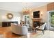 Well-lit living room with hardwood floors, fireplace, and balcony at 2400 E Cherry Creek South Dr # 307, Denver, CO 80209