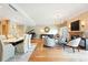 Open living and dining area with piano, fireplace, and hardwood floors at 2400 E Cherry Creek South Dr # 307, Denver, CO 80209