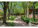 Scenic walkway through a tranquil green space with brick pavers and mature trees offering a relaxing atmosphere at 2400 E Cherry Creek South Dr # 307, Denver, CO 80209