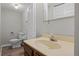 Basement bathroom with toilet, sink, and vinyl flooring at 4795 S Yank Way, Morrison, CO 80465