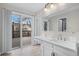 Bathroom with double vanity and access to deck at 4795 S Yank Way, Morrison, CO 80465