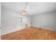 Bright dining room with hardwood floors and view into living room at 4795 S Yank Way, Morrison, CO 80465