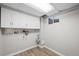 Basement laundry room with cabinets and hookups at 4795 S Yank Way, Morrison, CO 80465