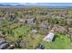 Scenic aerial shot of a residential neighborhood with lush greenery and views of a lake at 10490 W 78Th Ave, Arvada, CO 80005