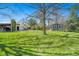 Large lot with a grass lawn, shed, outbuilding and several mature trees at 10490 W 78Th Ave, Arvada, CO 80005
