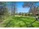Spacious backyard with large trees and split-rail fence at 10490 W 78Th Ave, Arvada, CO 80005