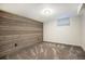 Finished basement with wood accent wall, neutral carpet, and natural light at 10490 W 78Th Ave, Arvada, CO 80005