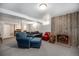 Cozy basement living area with a wood paneled accent wall, fireplace, and comfortable seating at 10490 W 78Th Ave, Arvada, CO 80005