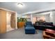 Finished basement featuring a large aquarium, a dark sofa and a comfortable armchair and ottoman at 10490 W 78Th Ave, Arvada, CO 80005
